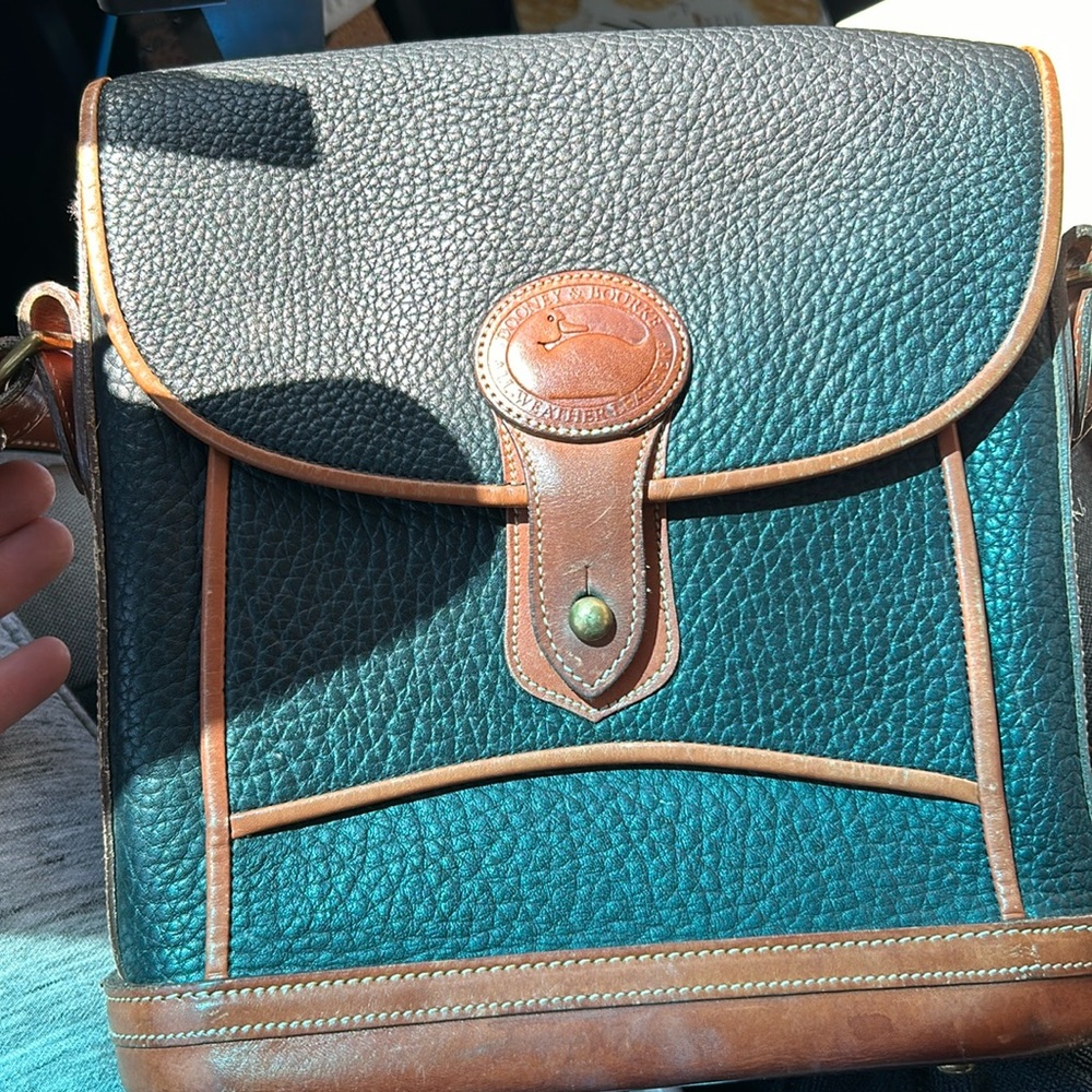 Dooney and Bourke leather black purse with brown leather trim.